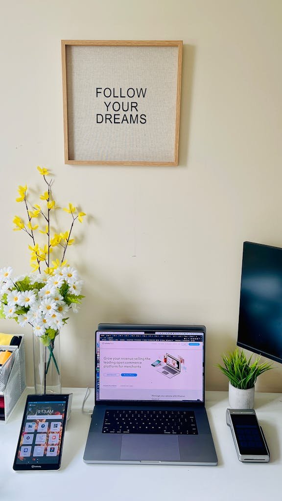 Modern workspace featuring a laptop and motivational decor for productivity.